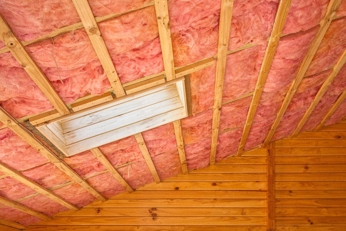 A ceiling with fiber glass insulation